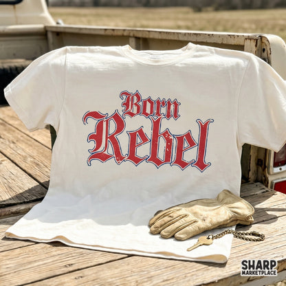 Distressed red and blue gothic text reading Born Rebel on a white shirt mockup, perfect for western-inspired biker apparel and DIY printing.