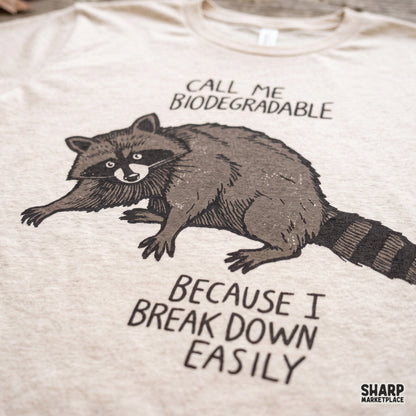 Funny raccoon digital PNG graphic with sarcastic quote reading Call Me Biodegradable for t-shirt sublimation
