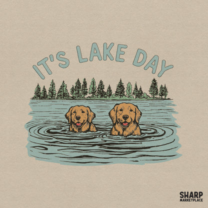 Retro style digital design featuring two golden retrievers swimming in a lake with pine trees and the arched text It's Lake Day for summer apparel.