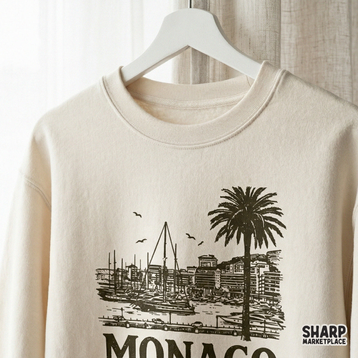 Monaco coastal travel design on a cream sweatshirt mockup, showcasing a detailed harbor scene with palm trees and seagulls for DIY prints.