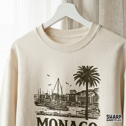 Monaco coastal travel design on a cream sweatshirt mockup, showcasing a detailed harbor scene with palm trees and seagulls for DIY prints.