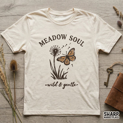 Boho style butterfly and dandelion illustration on a t-shirt mockup, featuring the quote Meadow Soul and wild and gentle in earthy tones.