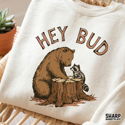 Whimsical forest animal graphic with a bear and raccoon on a tree stump, designed with vintage-style lettering for DIY stickers, mugs, and printable art.