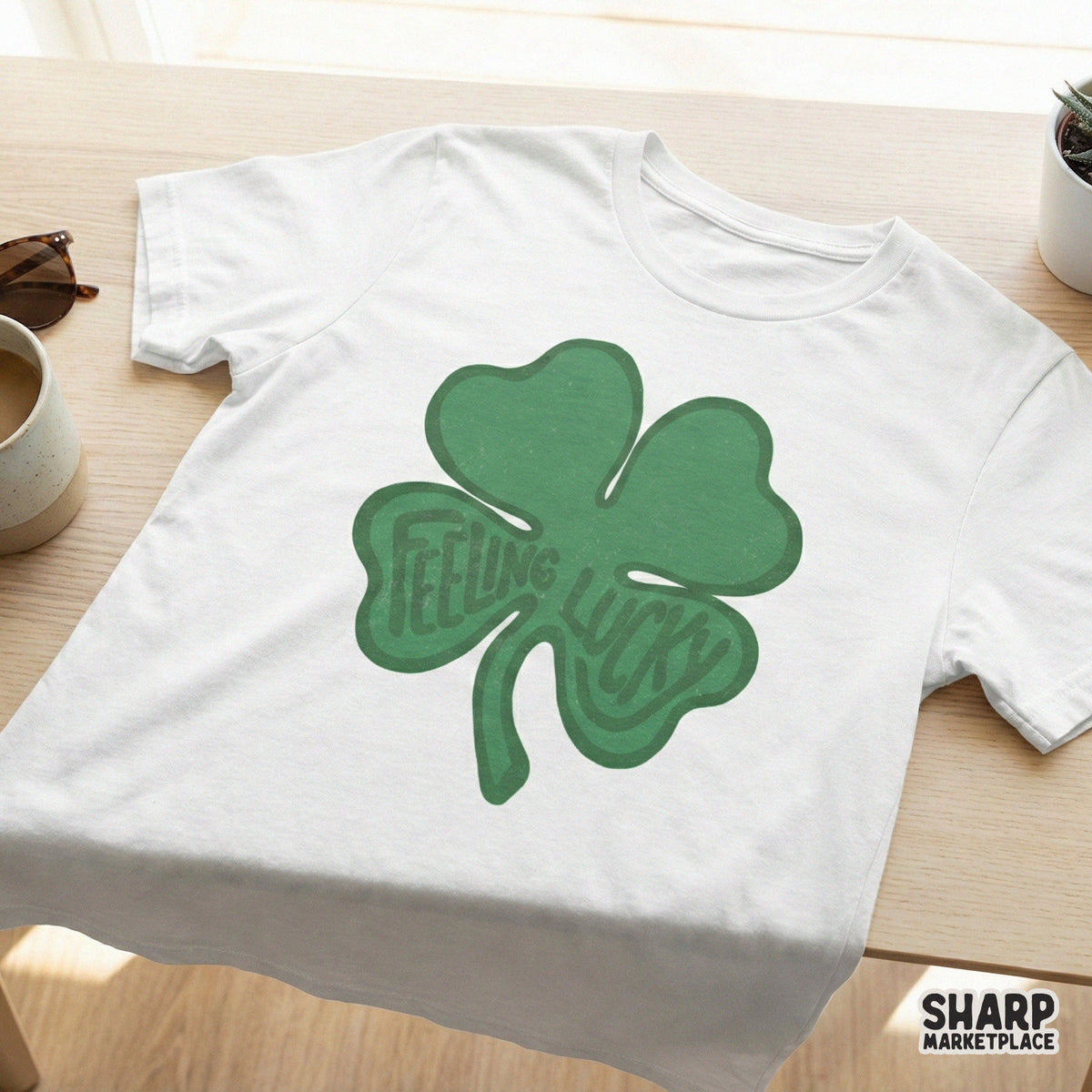 White t-shirt mockup displaying a green four-leaf clover design with retro Feeling Lucky typography, perfect for St. Patrick's Day apparel.