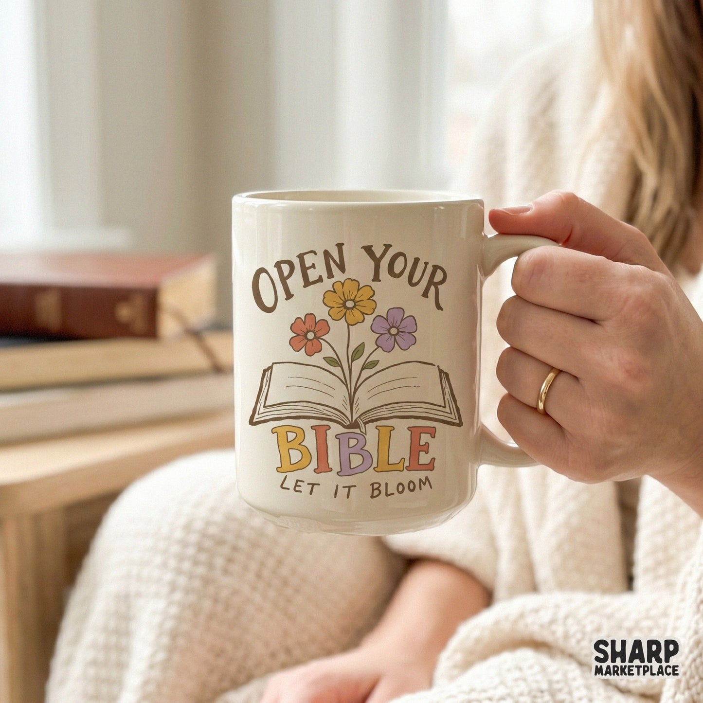 Digital sublimation design on a coffee mug showing an open book with blooming flowers and the inspirational text Open Your Bible Let It Bloom.