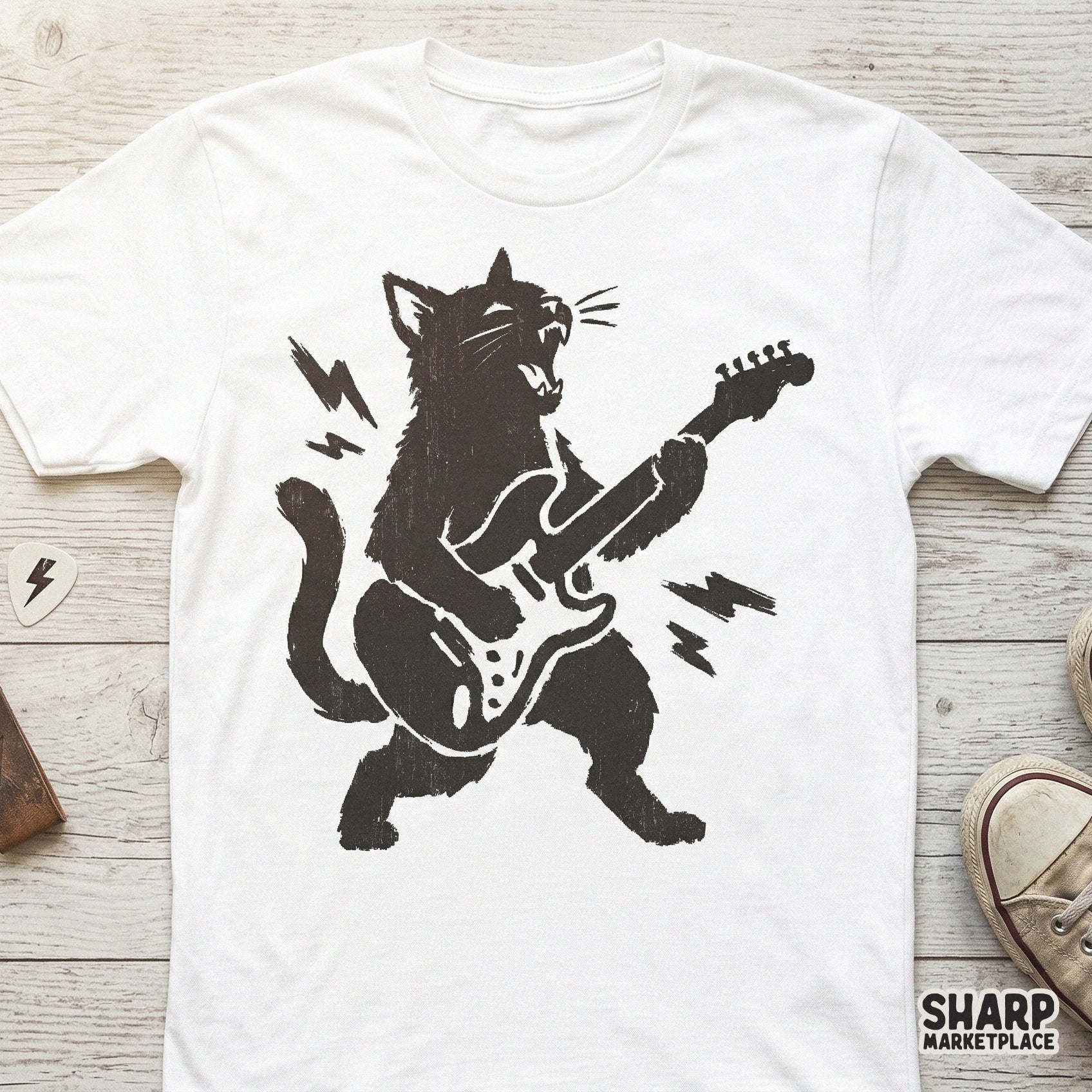 Gritty hand-drawn black cat shredding on an electric guitar, featured as a monochromatic graphic for custom t-shirt printing and band merch.