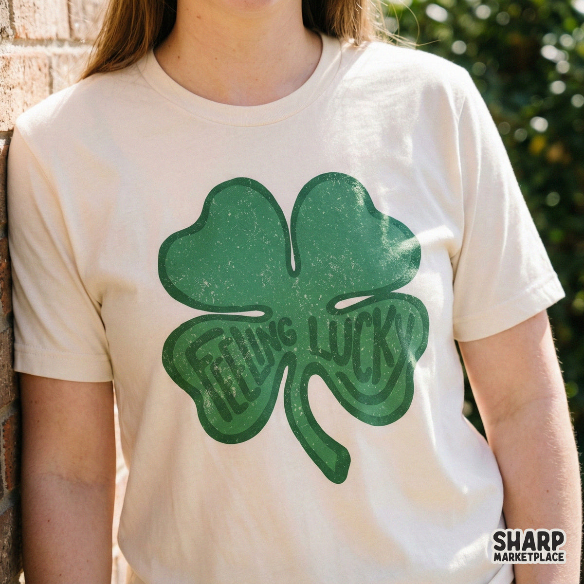 Distressed emerald green shamrock illustration with hand-lettered Feeling Lucky text, ideal for sublimation transfers and custom holiday clothing.