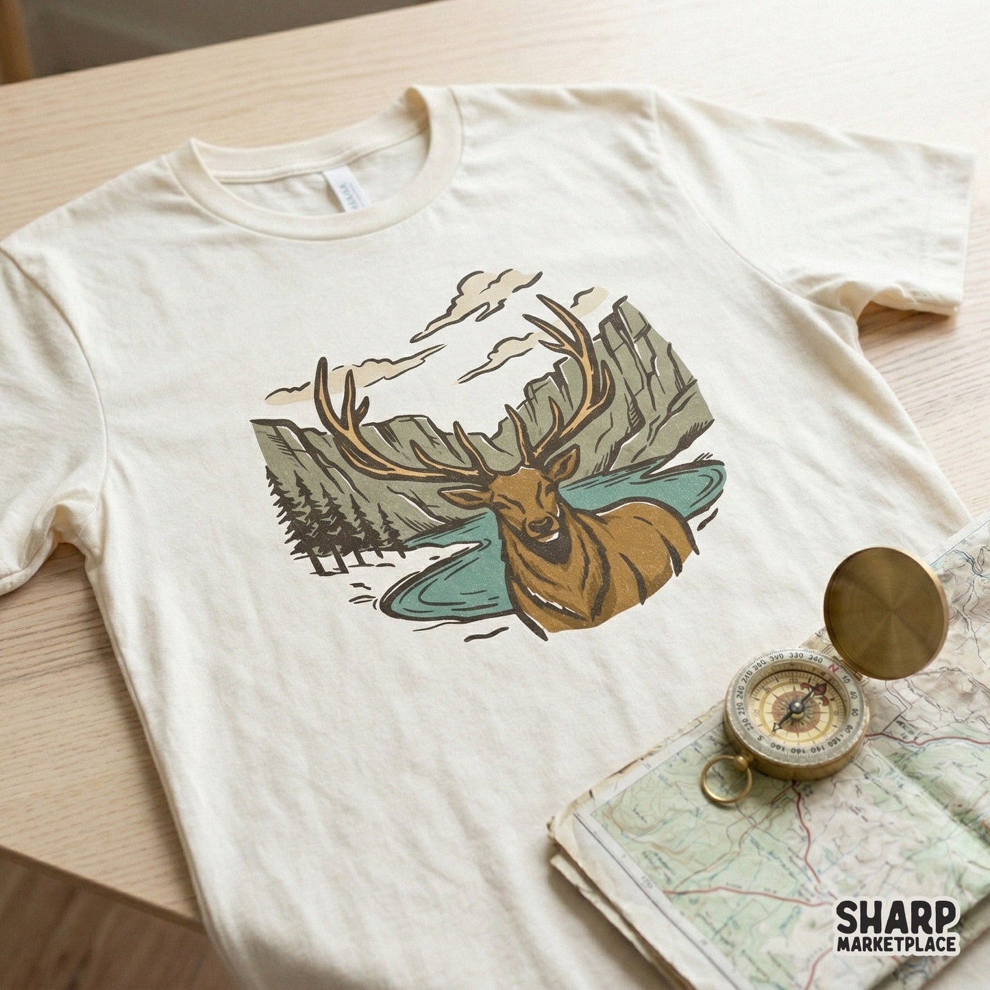 Vintage style elk and canyon wilderness graphic printed on a cream t-shirt, perfect for outdoor apparel, sublimation, or custom nature-themed clothing.