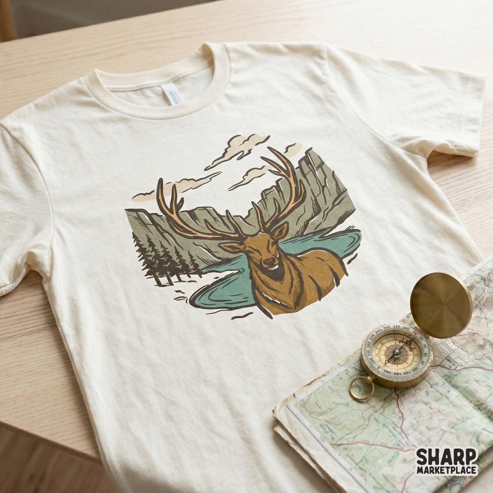 Vintage style elk and canyon wilderness graphic printed on a cream t-shirt, perfect for outdoor apparel, sublimation, or custom nature-themed clothing.