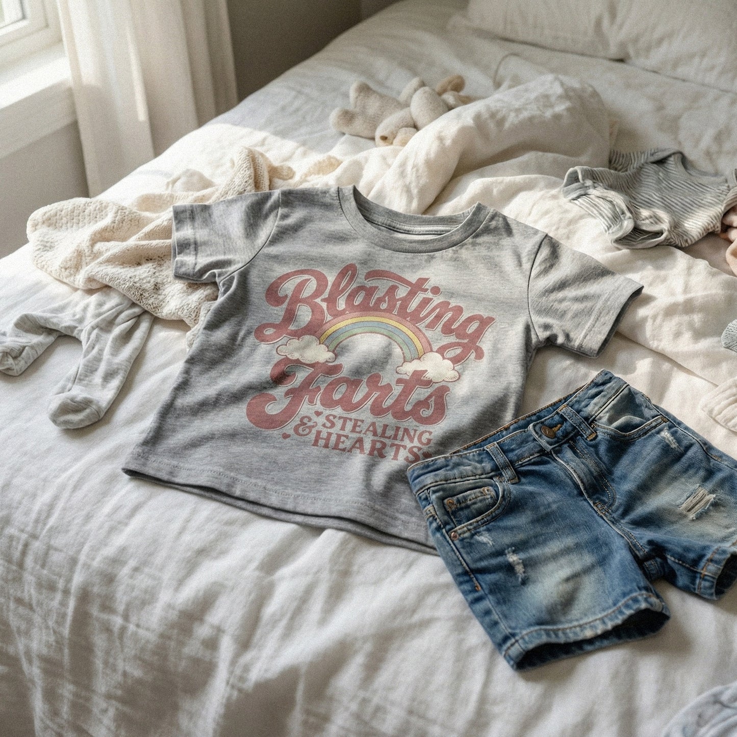 Distressed vintage aesthetic graphic with a rainbow, clouds, and playful text about blasting farts and stealing hearts for custom stickers or kids clothing.