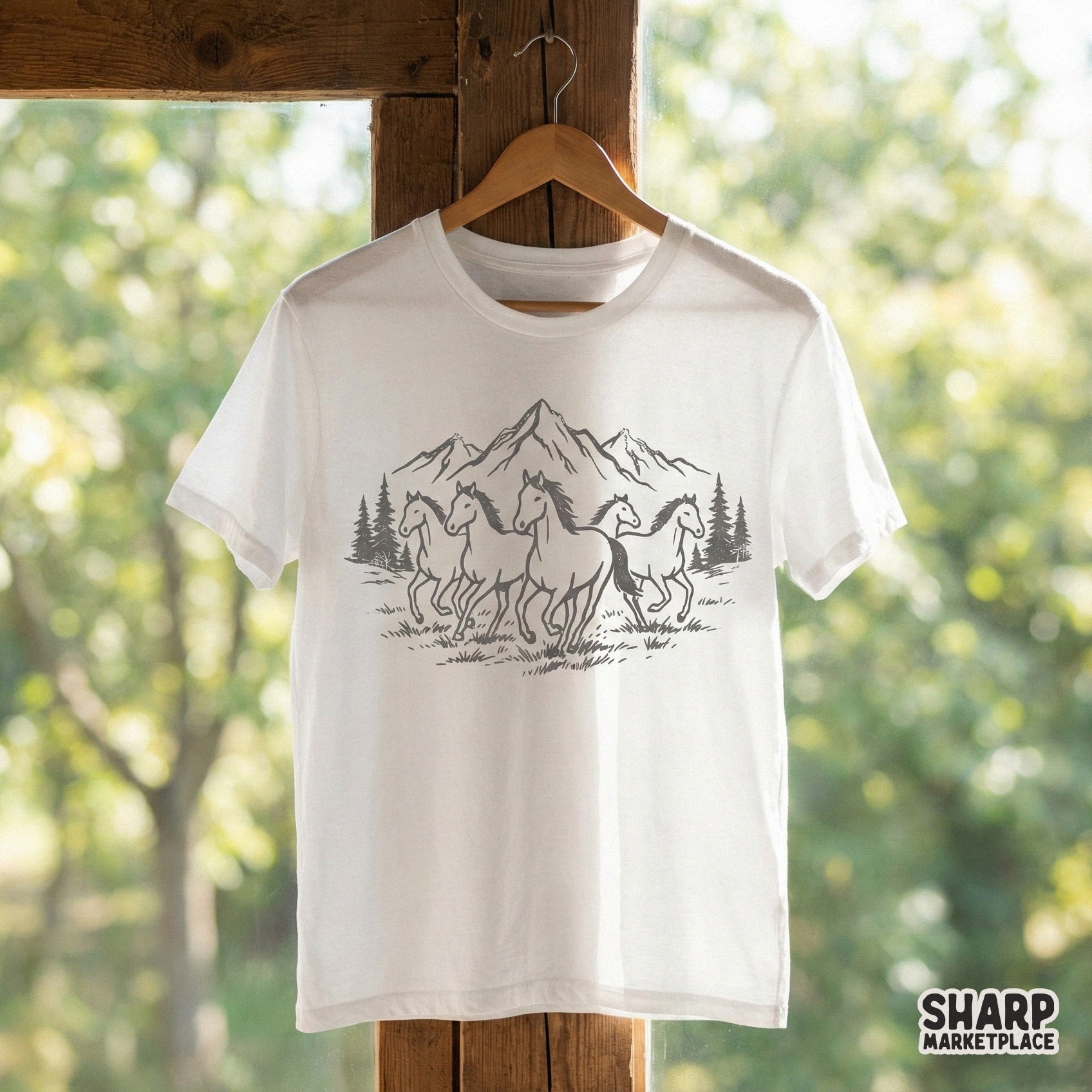 Hand-drawn western style graphic of wild horses in a mountain setting, ideal for creating custom shirts, stickers, or rustic home decor projects.