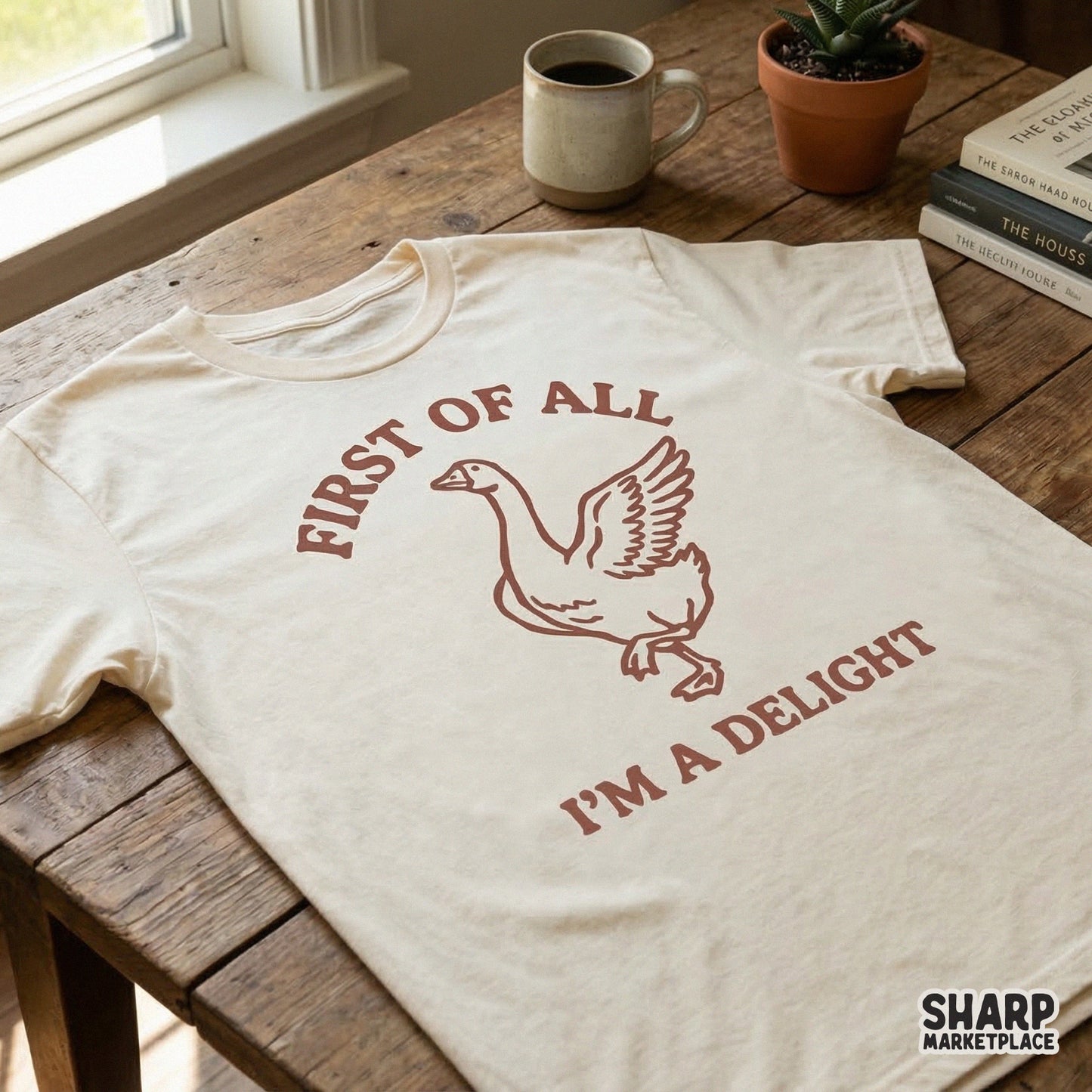 A cream colored t-shirt featuring a hand-drawn brown goose graphic with the witty quote First Of All I'm A Delight for custom sublimation projects.