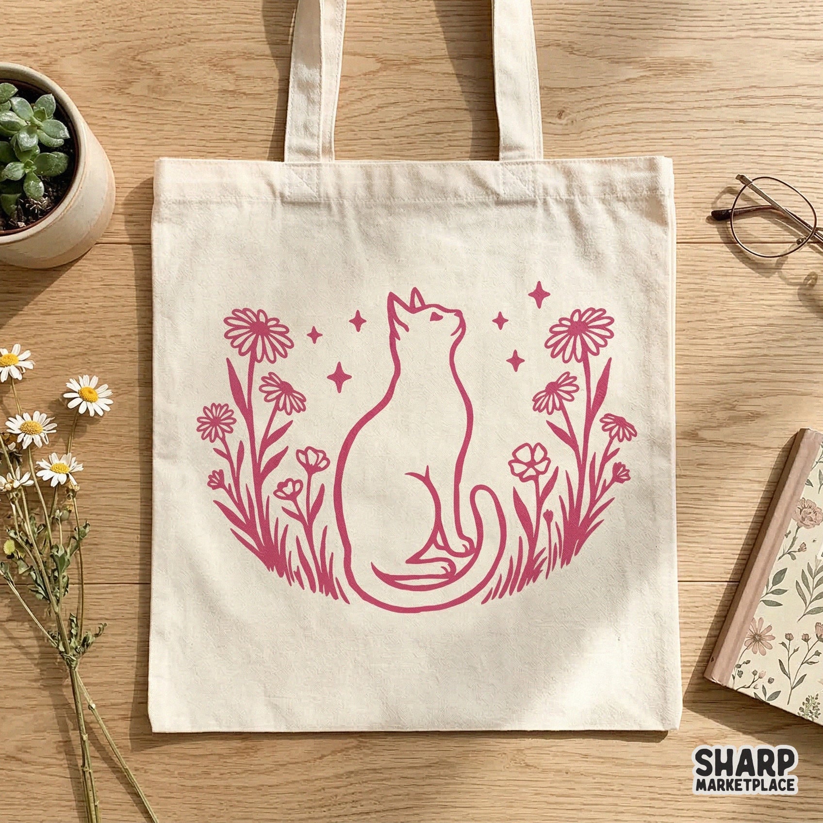 Boho floral cat design in deep pink featuring a graceful feline silhouette amidst daisies and stars, displayed as a print on a cotton tote bag.
