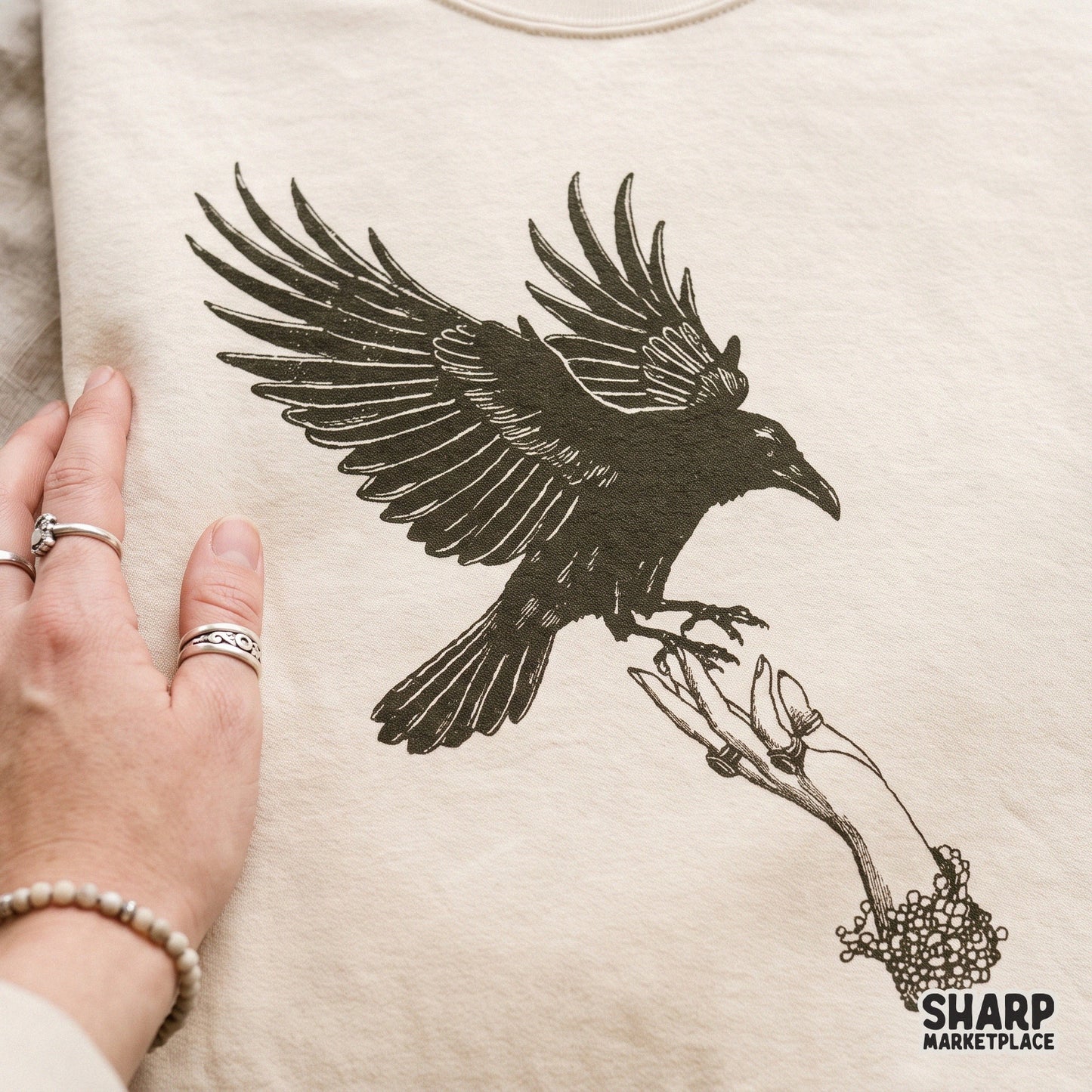 Retro horror black raven landing on a creepy jeweled hand gothic halloween png for spooky season shirts and stickers