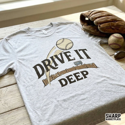 Vintage sports apparel design showing a baseball soaring past a scoreboard with the quote Drive It Deep, perfect for sublimation and t-shirt printing.
