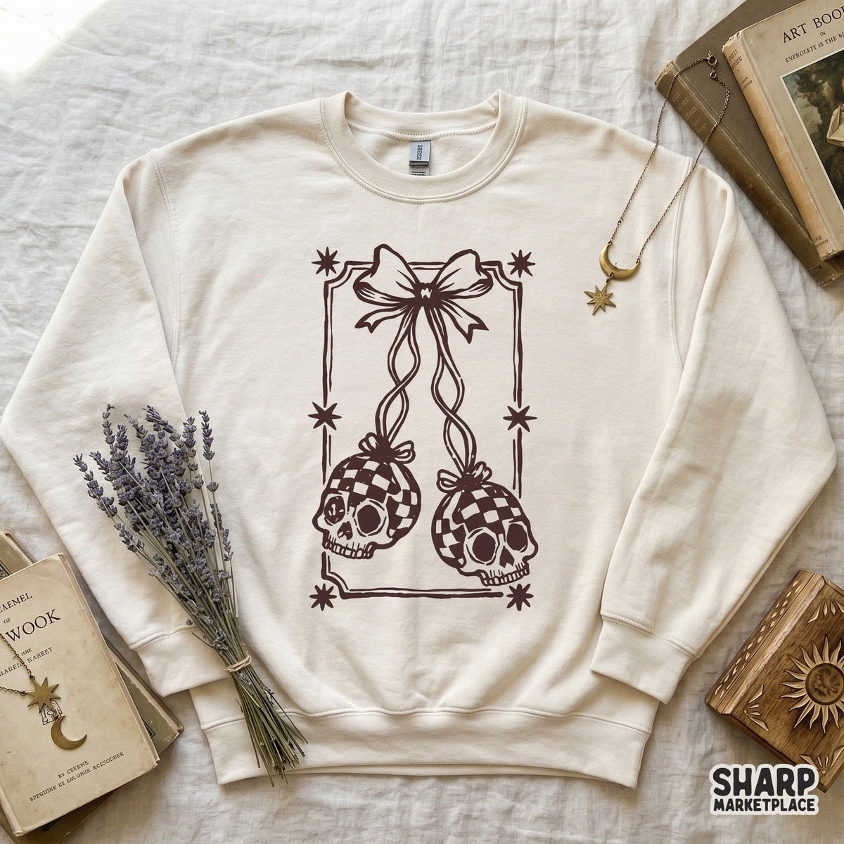 Digital download featuring a gothic coquette aesthetic with two skulls in a checkered pattern, suspended by a bow inside a decorative star frame.