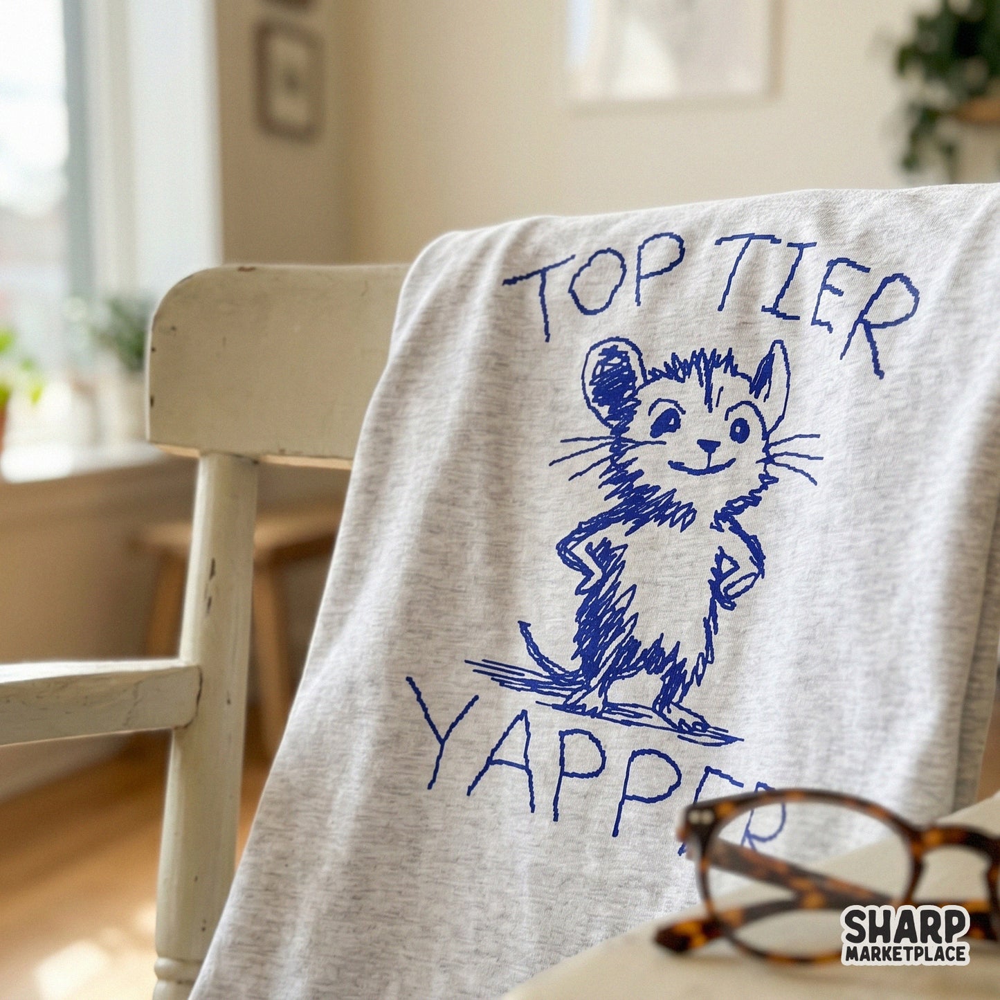 A hand-drawn blue mouse character standing with hands on its hips, paired with the text Top Tier Yapper, ideal for trendy sublimation and apparel.