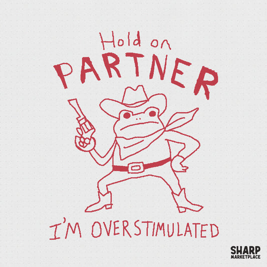 Hand-drawn red ink doodle of a cowboy frog wearing a hat and bandana, holding a revolver, with the text Hold on Partner I’m Overstimulated.