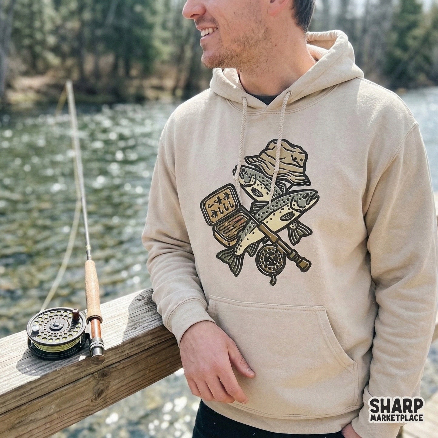 High-resolution fishing gear PNG featuring a fly fishing reel and trout, ideal for creating custom tumblers, stickers, and vintage-style apparel.