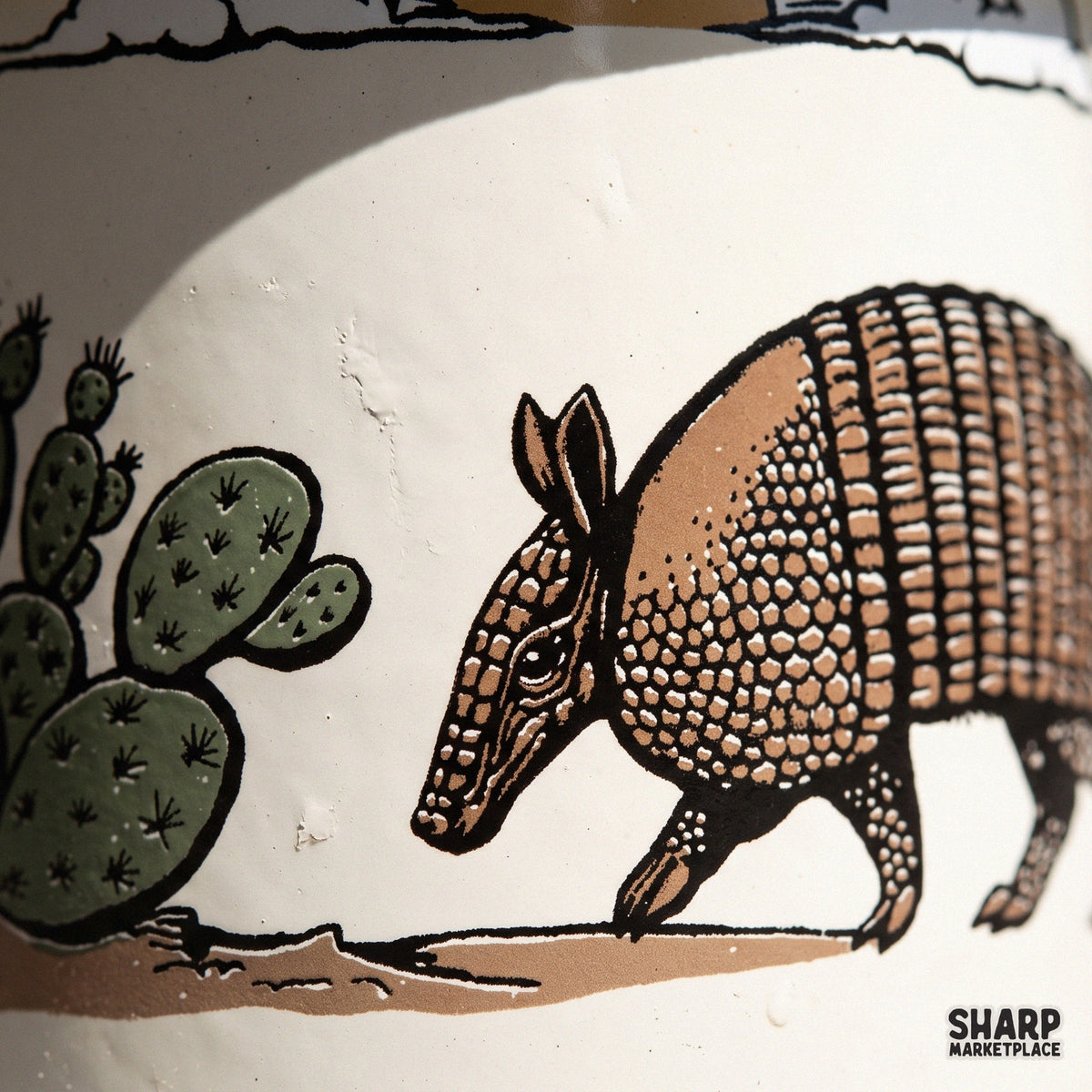 Vintage armadillo walking past a prickly pear cactus desert scene, western png sublimation design for t-shirts
