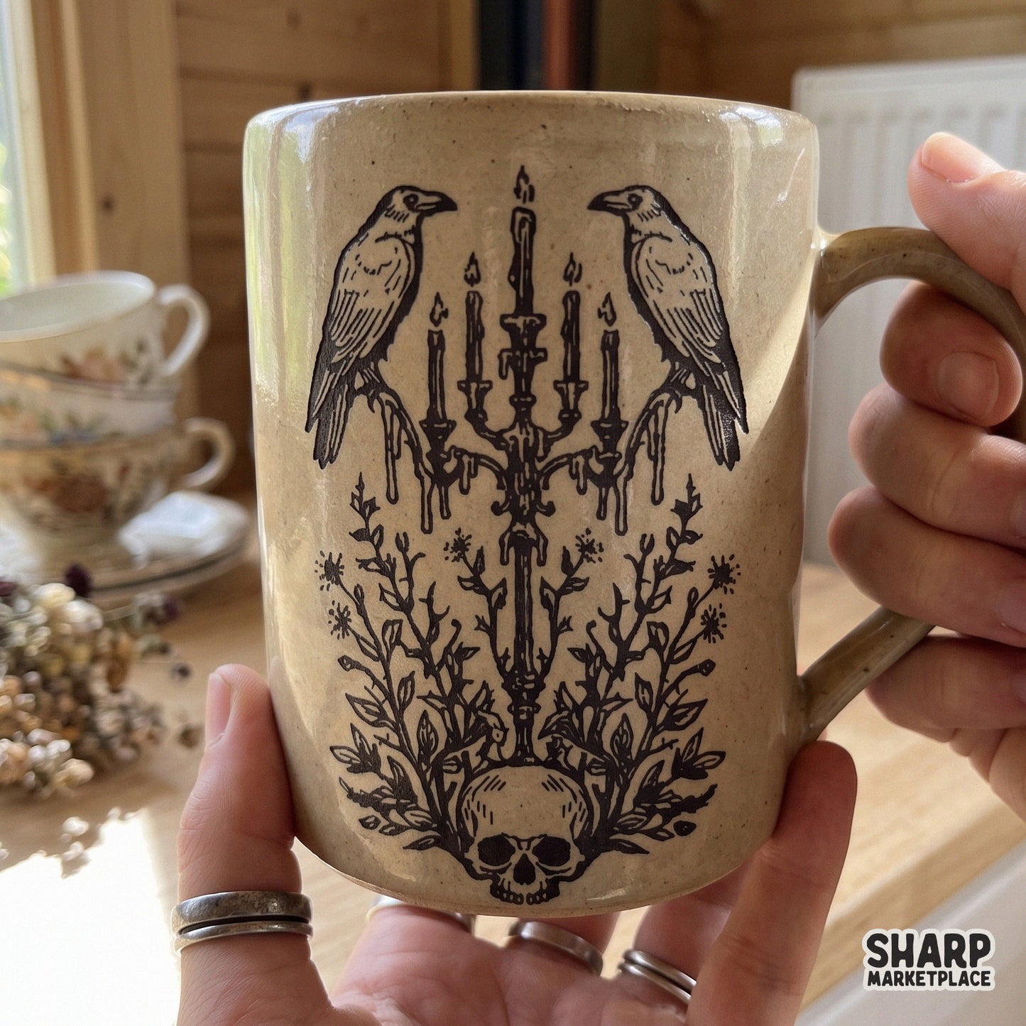 Two ravens on a candelabra over a floral skull, gothic horror design for spooky season apparel and Halloween decor PNGuffort