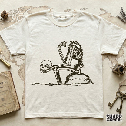 Detailed digital PNG of a pensive skeleton in a kneeling pose, designed with a moody, vintage aesthetic for sublimation and custom graphic tees.