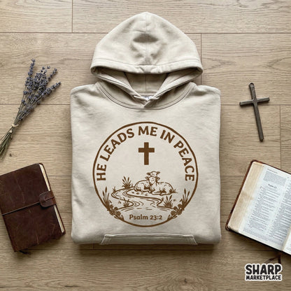 Vintage-style religious digital design featuring a cross, lambs, and a winding stream with the quote He Leads Me In Peace for sublimation projects.