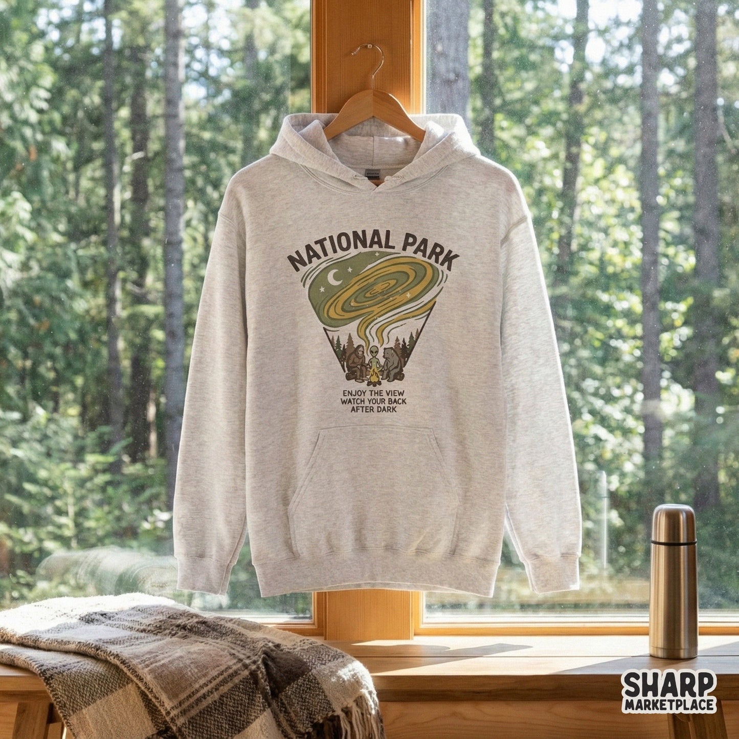 Digital camping badge design with a triangular layout, featuring a campfire scene with a forest creature, bear, and alien, perfect for t-shirts or stickers.