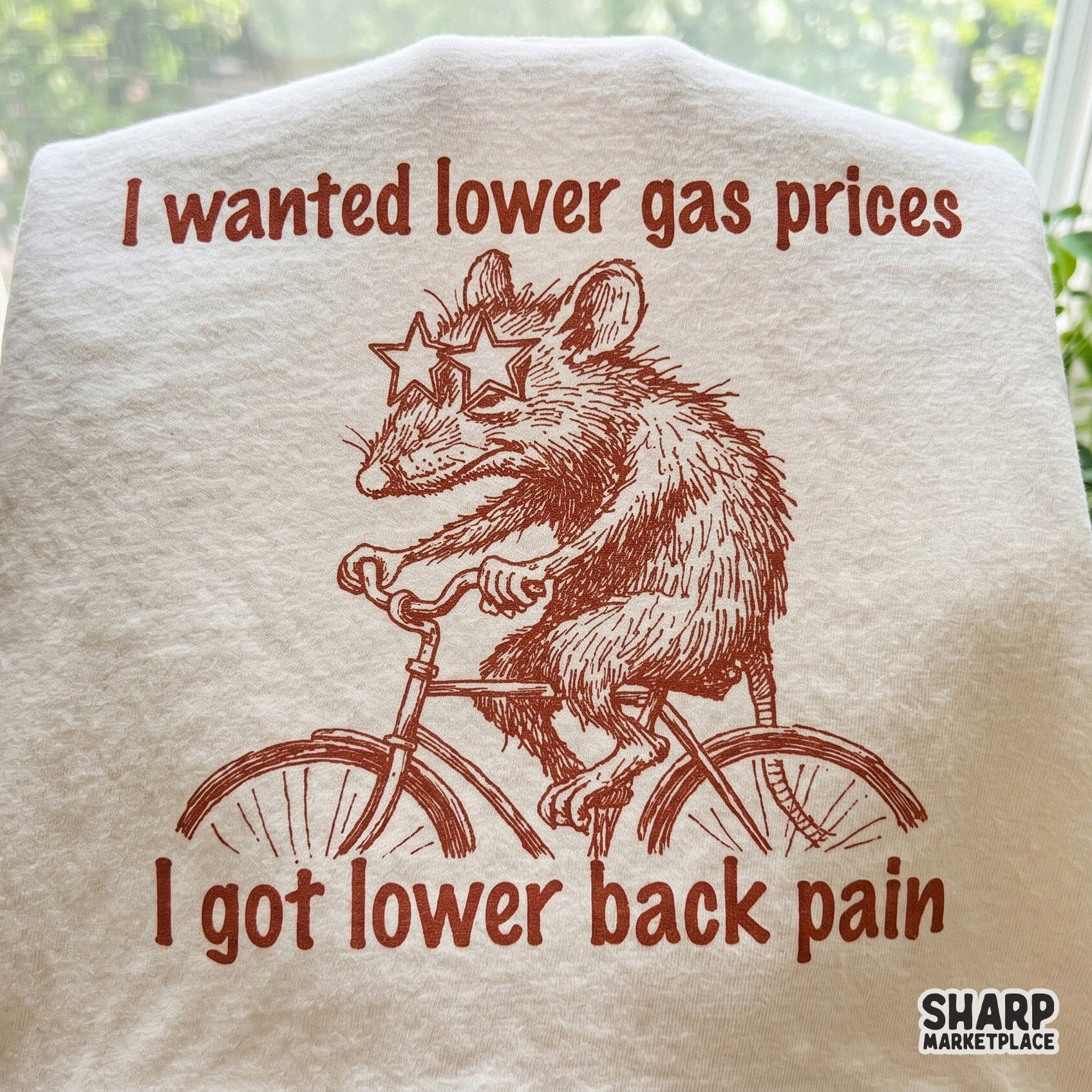 Digital download design featuring a hand-drawn possum in star glasses riding a bicycle with retro typography for funny t-shirts and sublimation projects.