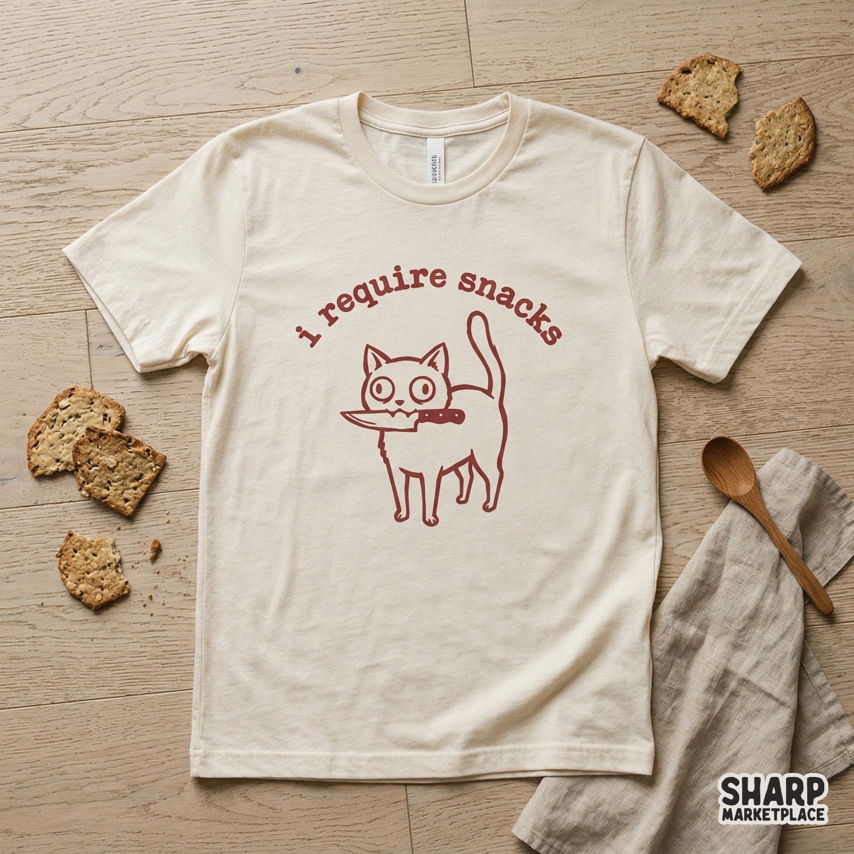 Sarcastic cat design with a knife and the words I require snacks in a rustic red font, suitable for custom stickers, tumblers, and graphic t-shirt projects.