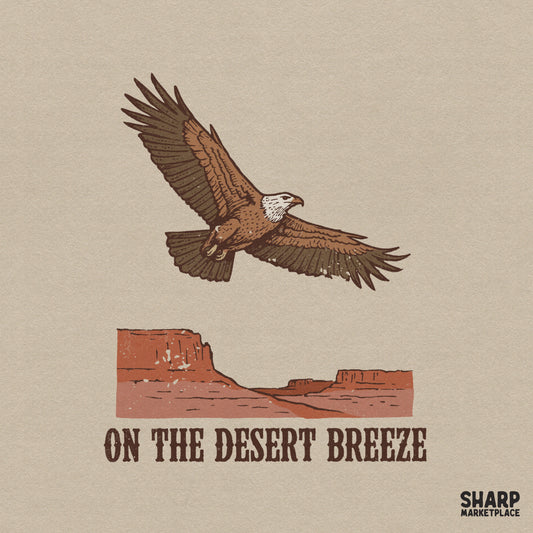 Vintage western design featuring a soaring eagle above a rustic red mesa canyon with the text On The Desert Breeze in distressed serif font.