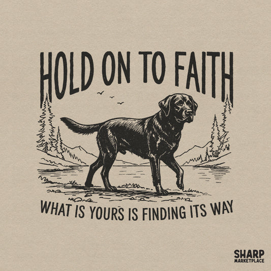 Vintage style black Labrador retriever design with mountains and lake, featuring the text Hold On To Faith and What Is Yours Is Finding Its Way.