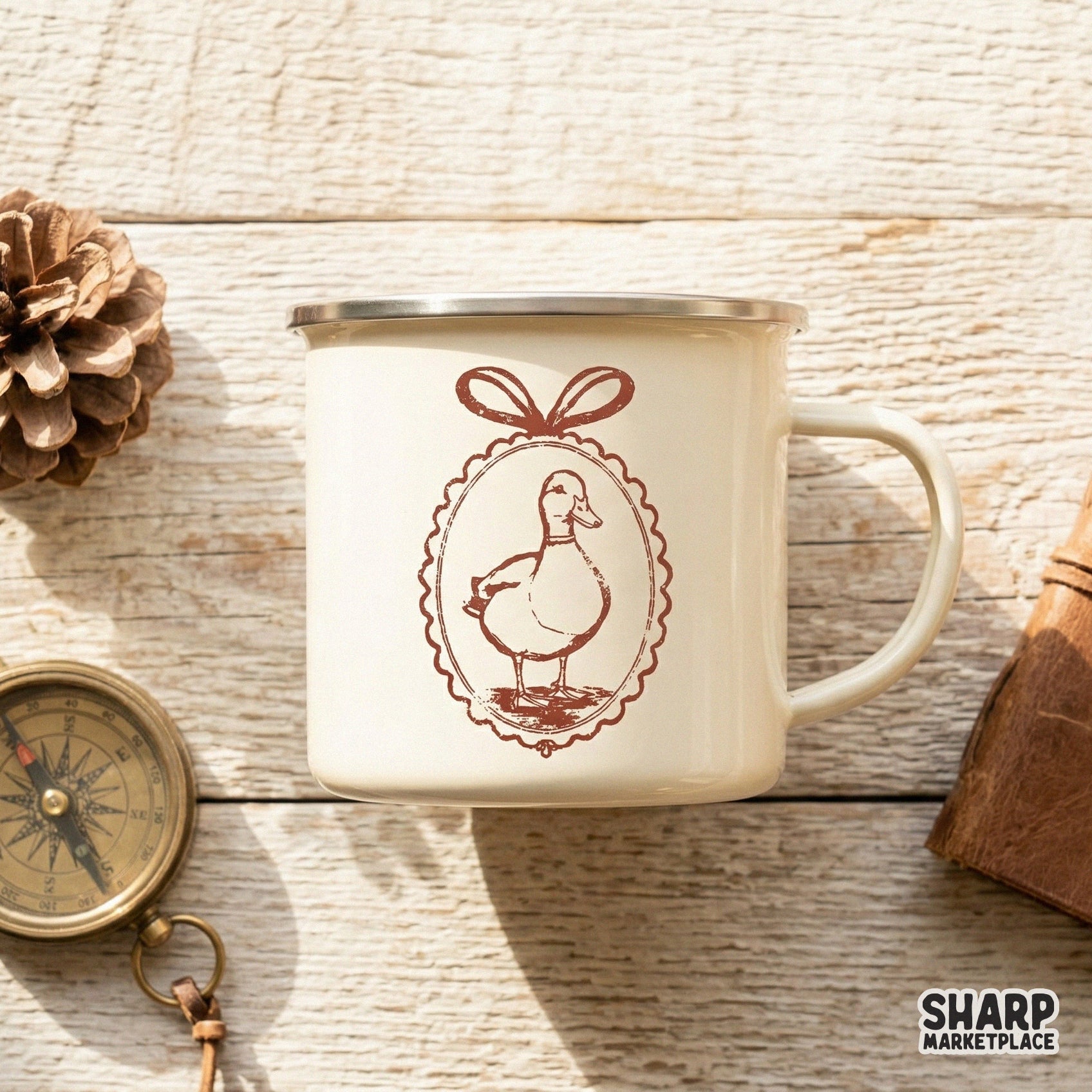 Terracotta colored vintage duck cameo design featuring a decorative bow frame, displayed on a cream-colored enamel mug for sublimation inspiration.