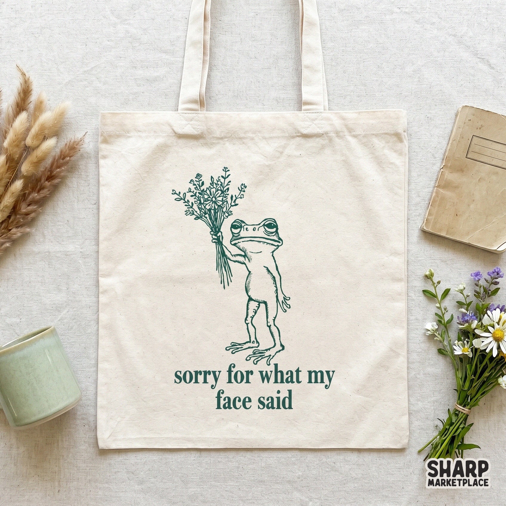 Sarcastic frog illustration with a bouquet of wildflowers and vintage serif typography, perfect for creating funny meme-themed t-shirts and custom stickers.