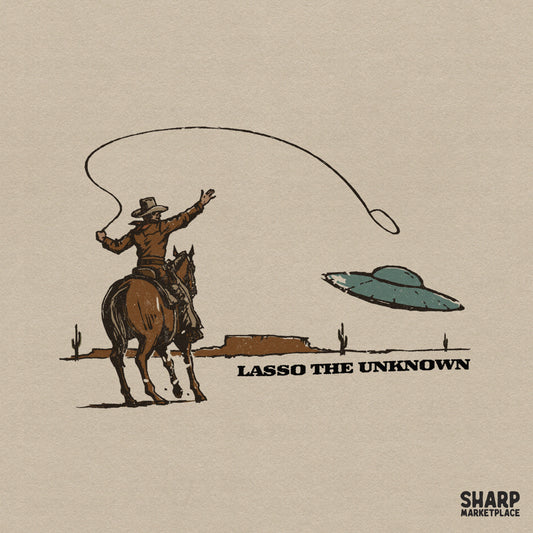 Retro western graphic featuring a cowboy on horseback throwing a lasso at a flying saucer in a desert landscape with Lasso The Unknown text.