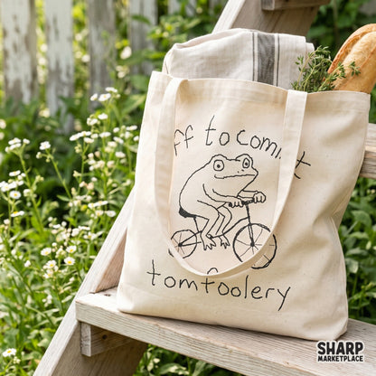 Minimalist black line art of a frog pedaling a bicycle, surrounded by the phrase Off to commit tomfoolery, ideal for DTF and shirt printing.