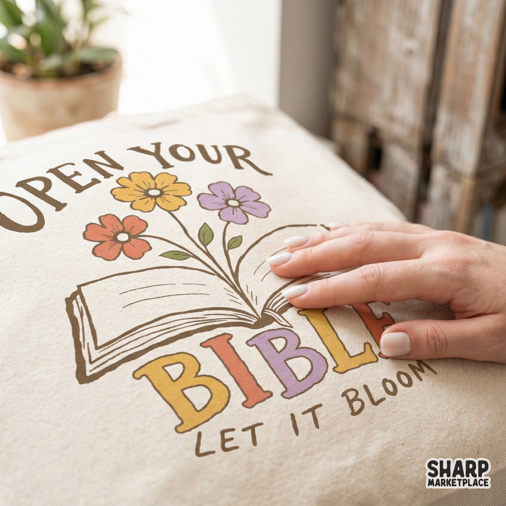 Hand-drawn open book design with a trio of flowers and retro lettering, suitable for creating faith-inspired bookmarks, posters, and apparel.