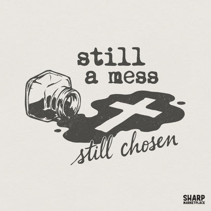 Digital design featuring a spilled ink bottle forming a dark puddle with a white cross silhouette, with the text Still a mess still chosen in vintage fonts.
