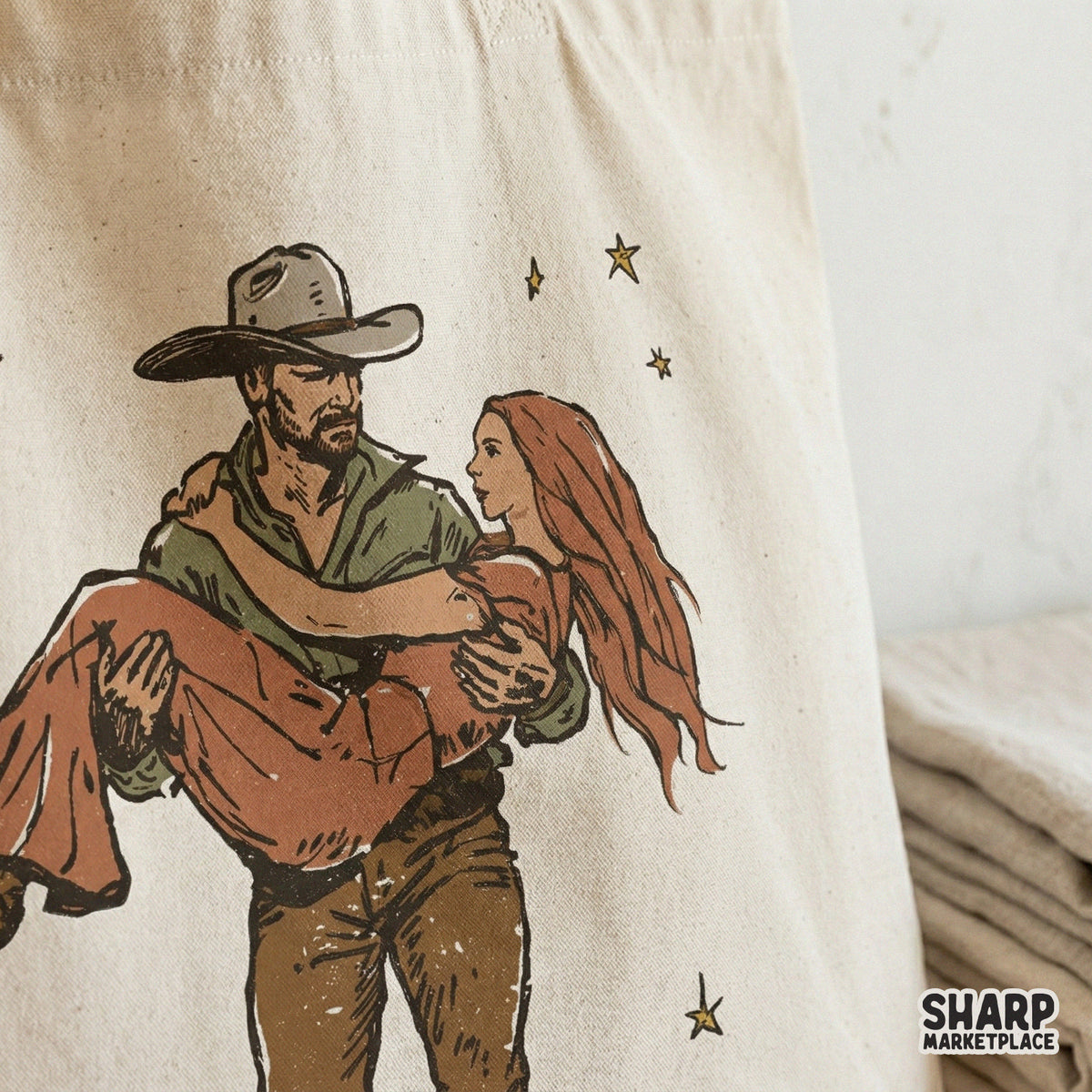 Romantic cowboy carrying a woman through golden stars, featuring a distressed texture for trendy country-themed apparel and DIY craft projects.