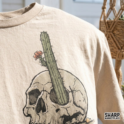 Gothic western digital design featuring a weathered skull and blooming cactus, perfect for retro t-shirt prints, stickers, and spooky wall art.