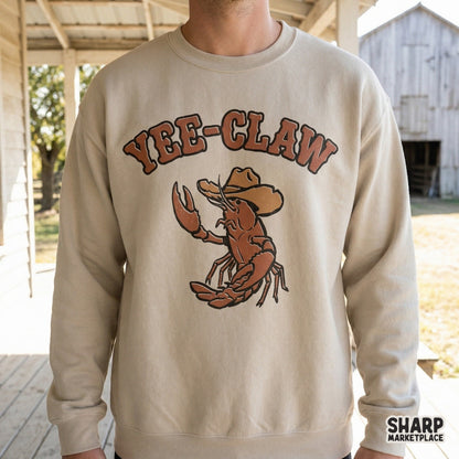A vintage-style illustration of a cowboy crawfish with the punny phrase Yee-Claw, perfect for coastal rodeo themed t-shirts and summer stickers.