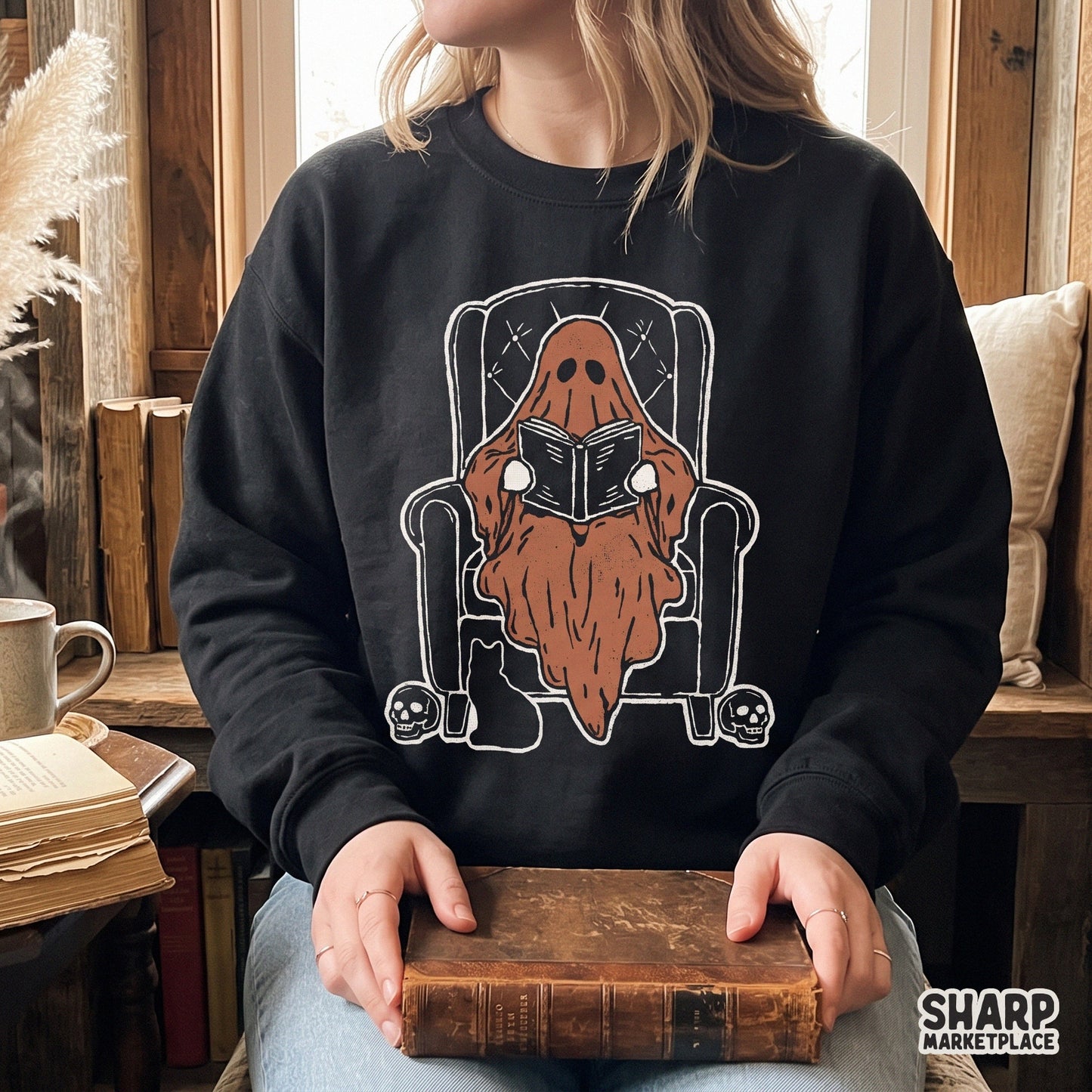 Cute ghost reading a book in an armchair sublimation PNG for a spooky season fall t-shirt design