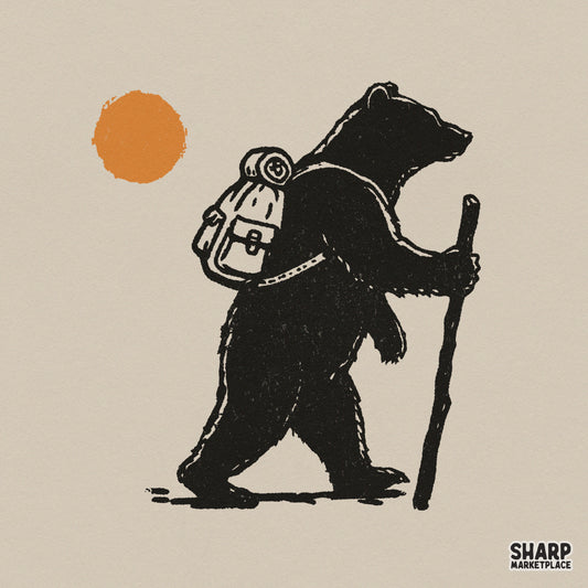 Rustic black silhouette of a hiking bear with a backpack and walking stick under an orange sun, perfect for woodland-themed apparel designs.