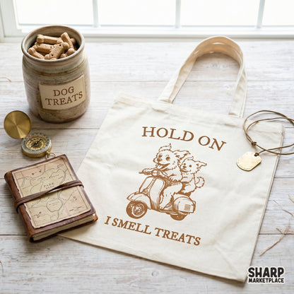 Retro style dog scooter illustration on a canvas tote bag, featuring two dogs riding and the text Hold On I Smell Treats.