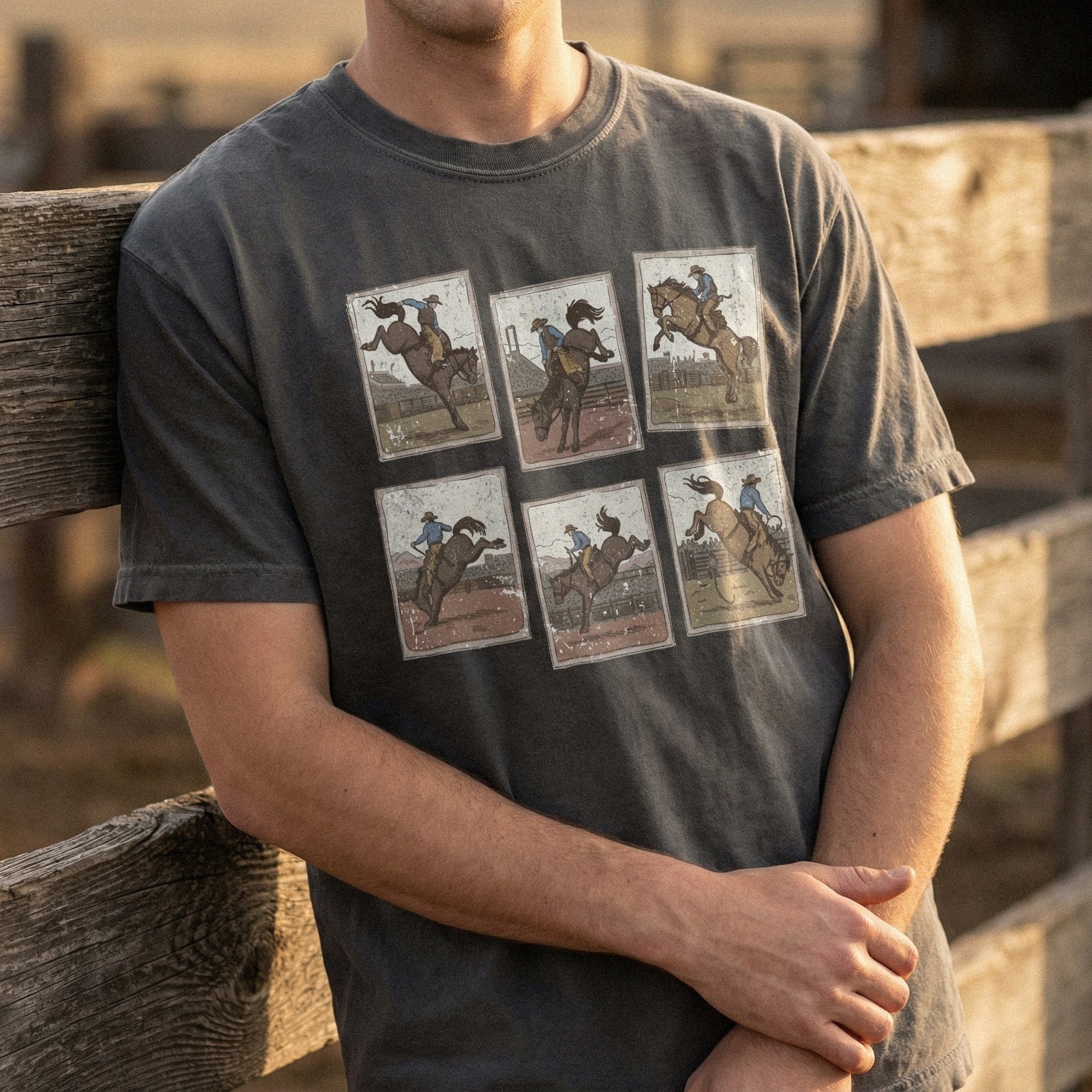 Distressed vintage cowboy art on a dark gray t-shirt, showcasing a six-panel rodeo bronco rider collection for western-themed apparel.