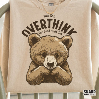 Digital design featuring a thoughtful bear cub and the quote You Can Overthink The Good Stuff Too, perfect for trendy t-shirts and stickers.