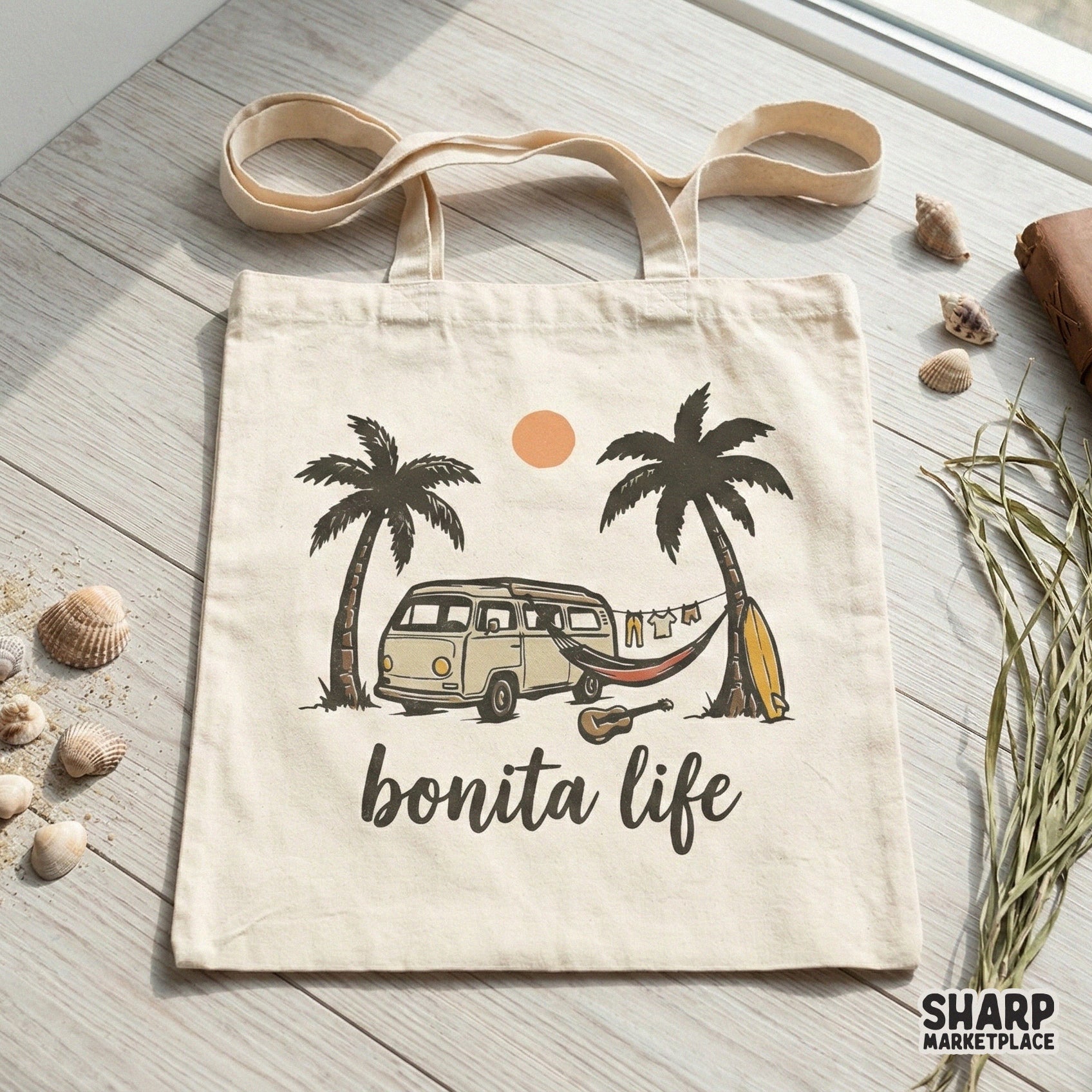 Tote bag mockup displaying a coastal summer graphic with a retro van, hammock, and palm trees under a warm orange sun, captioned Bonita Life.