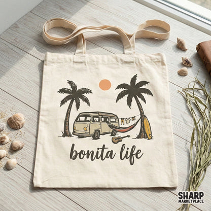 Tote bag mockup displaying a coastal summer graphic with a retro van, hammock, and palm trees under a warm orange sun, captioned Bonita Life.