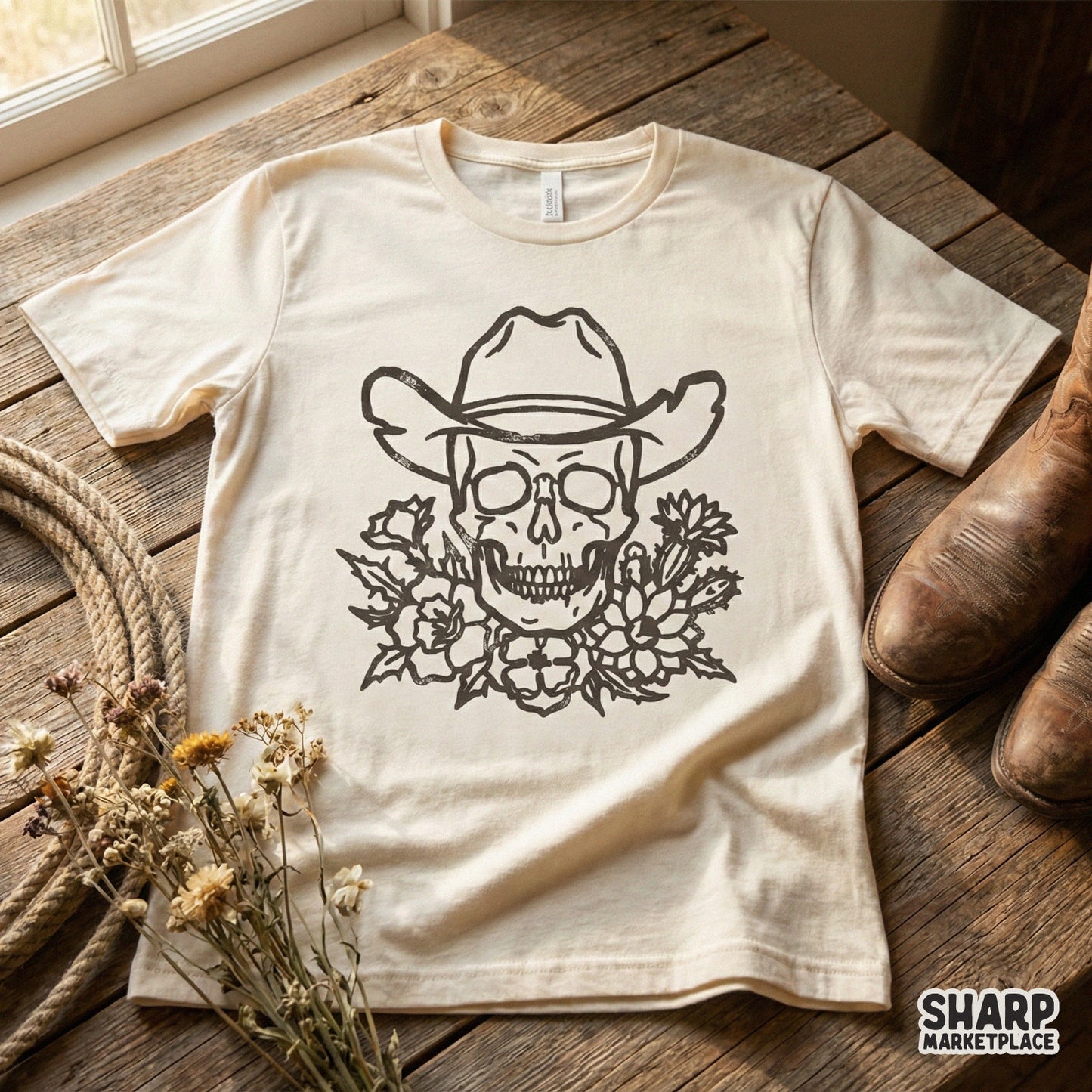 Detailed western skull design with a cowboy hat and desert floral bouquet, shown on a cream-colored t-shirt for a vintage, edgy aesthetic.