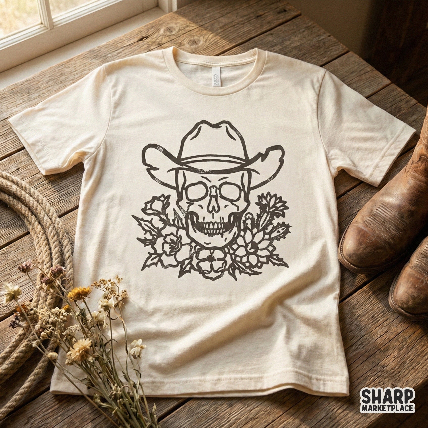Detailed western skull design with a cowboy hat and desert floral bouquet, shown on a cream-colored t-shirt for a vintage, edgy aesthetic.
